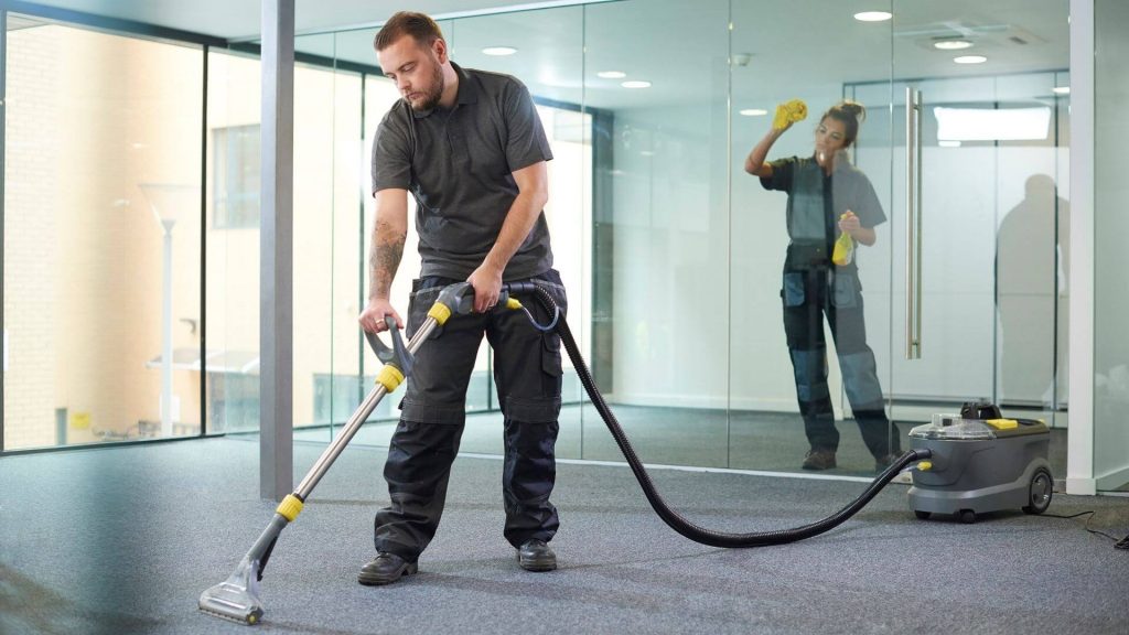 two cleaner in a uniform cleaning an office