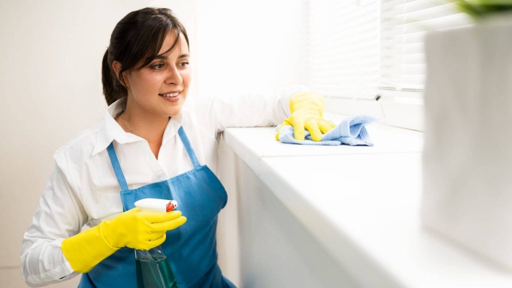 a woman cleaning a surface